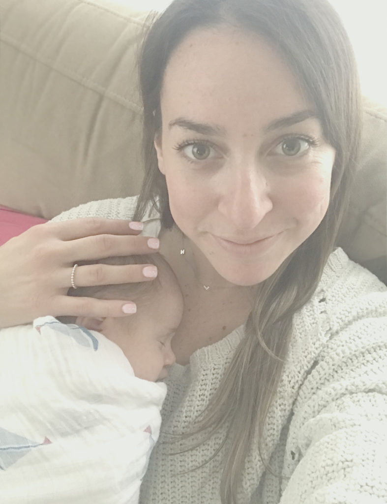 Danielle Brooke Postpartum Doula Holding newly born infant